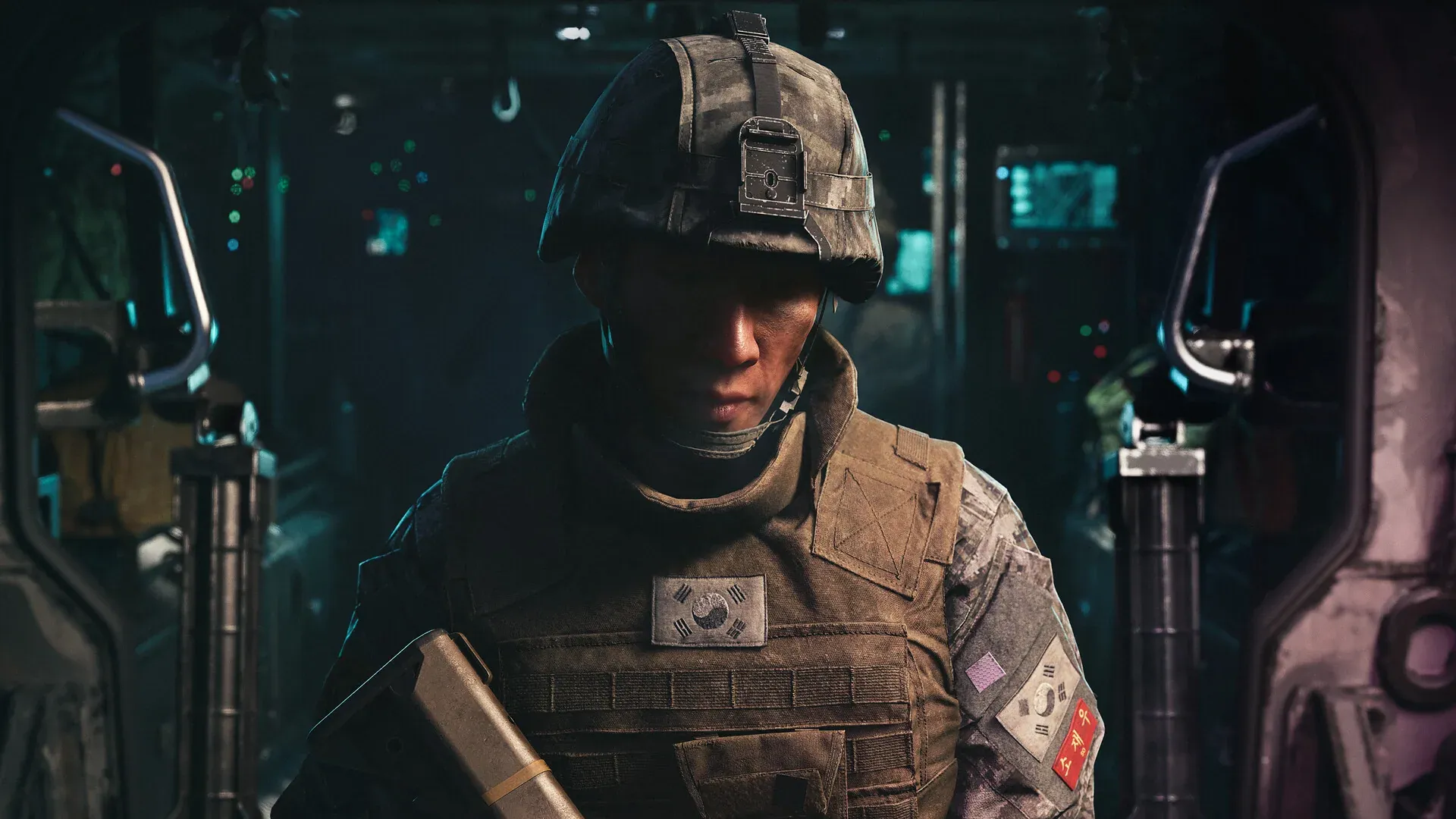 Soldier holding a rifle inside a hangar with equipment around