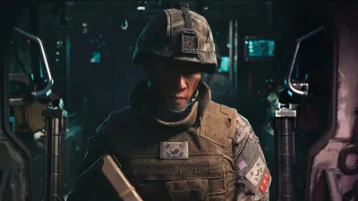 Soldier holding a rifle inside a hangar with equipment around