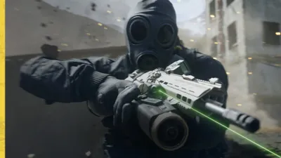 Soldier in a gas mask aiming a compact weapon with a green laser